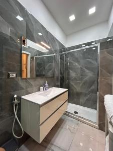 a bathroom with a sink and a shower at Casa Tolentino al centro di Napoli in Naples +10 photos
