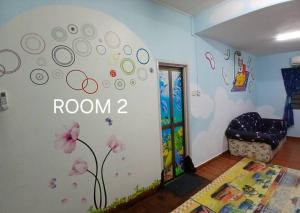 una stanza con un cartello "stanza" sul muro di Cartoon world homestay a Seremban