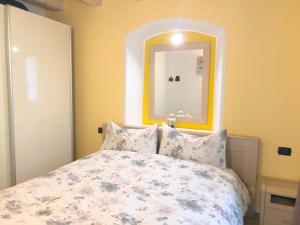 a bedroom with a bed with a mirror above it at Casa Vacanze La Romantica in Chiavenna