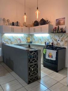 a kitchen with a stove and a counter top at Casa em Porto de Galinhas in Porto De Galinhas