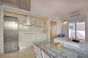 a kitchen with a glass table and a refrigerator at Beds & Breaks Pergolesi in Valencia
