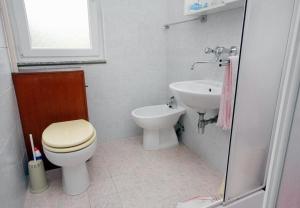 ein Badezimmer mit Toilette und Waschbecken in der Unterkunft Apartment Ljerka in Malinska