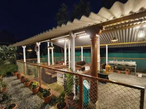 a pergola on a house with potted plants at Lake Flower Homestay in Chikmagalūr