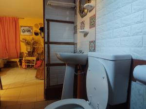 a bathroom with a white toilet and a sink at El REFUGIO DE KARIM in San Rafael +178 photos