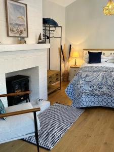 a bedroom with a bed and a fireplace at The Old Wash House in Lytham St Annes