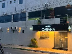 a store with a sign on the side of a building at Hotel Cabana in Parauapebas