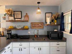 a kitchen with a sink and a microwave at The Mark at Surfside #5 in Surfside Beach