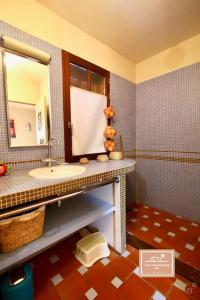 a bathroom with a sink and a mirror at Maison Yalis in La Seyne-sur-Mer