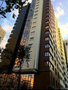 a tall building with a lot of windows on it at SkyHouse-High Comfort Gem in Central Downtown in Chişinău