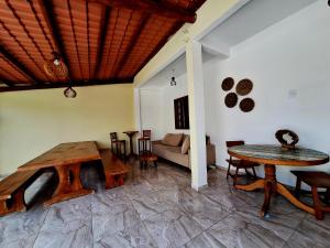 a living room with a table and chairs and a couch at Casa familiar Rústica in Porto Seguro
