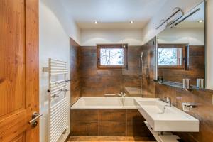 a bathroom with a tub and a sink at Lodge 3 Nordic Bath & Garden in Champéry +16 photos