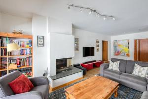 a living room with a couch and a table at Lodge 3 Nordic Bath & Garden in Champéry