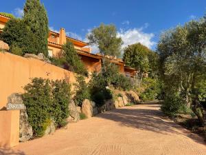 a road in front of a building with trees at Domaine Pietra di Sole in Porto-Vecchio