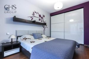 a bedroom with a bed and a large window at Beautiful apartment in the city center, Angel City in Kraków