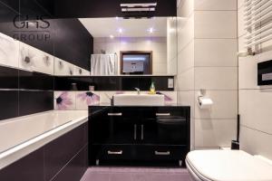a bathroom with a sink and a tub and a toilet at Beautiful apartment in the city center, Angel City in Kraków