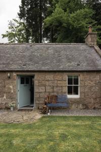 a stone building with a bench in front of it at The Bothy in Banchory