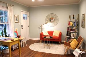 a living room with a red couch and a table at Oldfield Escape in Decatur