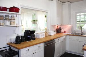 a kitchen with white cabinets and a wooden counter top at Oldfield Escape in Decatur