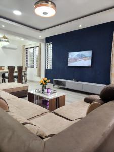 a living room with two couches and a tv at 2 bedroom Jab Villa in Adentan