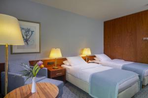 Postel nebo postele na pokoji v ubytování Maritim Hotel Darmstadt