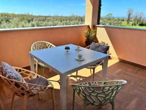 a table and chairs on a balcony with a view at Mila in Vodnjan