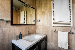 a bathroom with a white sink and a mirror at Apto en la playa a 20 min en tren de Barcelona in Cabrera de Mar +64 photos