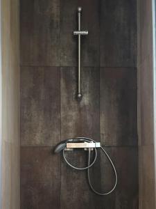 a shower in a bathroom with a cross on the wall at Apto en la playa a 20 min en tren de Barcelona in Cabrera de Mar