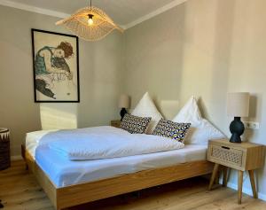 a bedroom with a bed with blue sheets and pillows at Ferienwohnungen an der Ammer in Oberammergau +61 photos