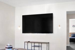 a flat screen tv hanging on a wall at Traveler's Place of Belleville in Belleville