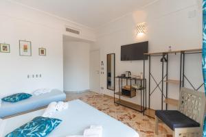 a small room with two beds and a tv at "Maiori" Cozy 3 Bedroom, 3 Bathroom House in the Heart of Maiori in Maiori