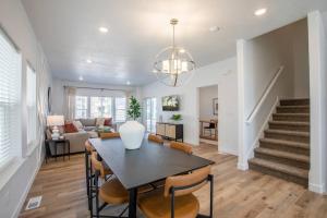 a dining room and living room with a table and chairs at Canyon Escape Luxury Ski home American Fork in American Fork