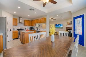 a kitchen and dining room with a wooden table at Blissful Heated Pool Retreat in Corpus Christi