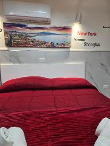 a bedroom with a red bed and a painting on the wall at Suite SAN GENNARO BIS in Naples +168 photos