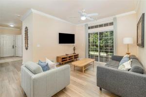 a living room with two couches and a tv at 1301 TT - Tranquil Retreat at Bella Piazza Condo for Relaxation and Comfort in Kissimmee