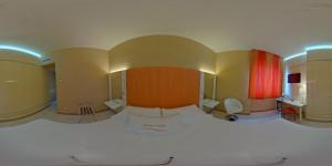 a view of a room with a bed and a mirror at Barion Hotel & Congressi in Bari