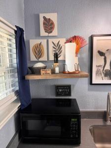 a microwave sitting on a counter in a kitchen at The Mark at Surfside #6 in Surfside Beach