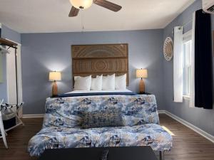 a bedroom with a bed with a couch and two lamps at The Mark at Surfside #6 in Surfside Beach
