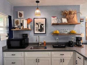 a kitchen with a sink and a microwave at The Mark at Surfside #6 in Surfside Beach