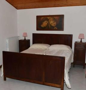 a bedroom with a large bed with two children on it at Cozy villa in Bagnoregio - 80 m² with air conditioning in Bagnoregio