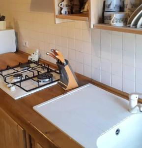 a kitchen counter with a stove top with a pair of scissors at Cozy villa in Bagnoregio - 80 m² with air conditioning in Bagnoregio