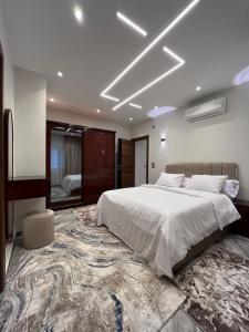 a bedroom with a large bed and a large rug at Zayed Plaza-زايد بلازا in Cairo