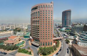 a tall building in a city with a street at Habtoor Metropolitan Palace Hotel in Beirut