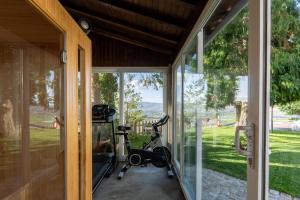 a room with a gym with a bike next to a window at Casa Avó Chiquinha in Montalegre