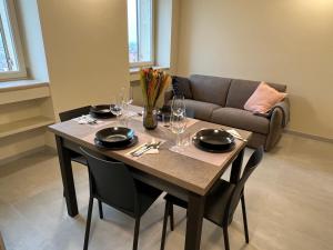 a dining room table with chairs and a couch at Stelle di Verona - Selene in Verona