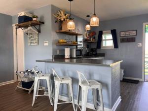 a kitchen with a counter and four stools at The Mark at Surfside #7 in Surfside Beach