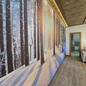 a hallway with a mural of trees on the wall at Trebevićki Raj 1 in Brus