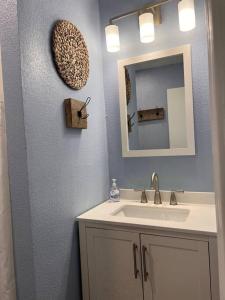 a bathroom with a sink and a mirror at The Mark at Surfside #7 in Surfside Beach