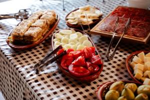 a table topped with bowls of fruit and other desserts at Elite Rooms Kolasin in Kolašin