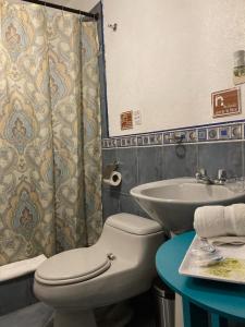 a bathroom with a toilet and a sink at Hotel Posada del Rey in Cuenca +44 photos