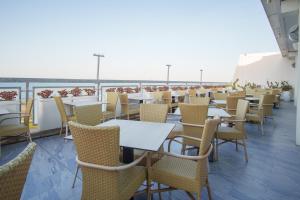 eine Reihe von Tischen und Stühlen auf einem Balkon in der Unterkunft Barion Hotel & Congressi in Bari